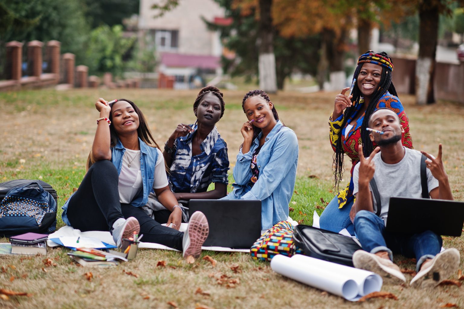 Group of five african college students spending time together on